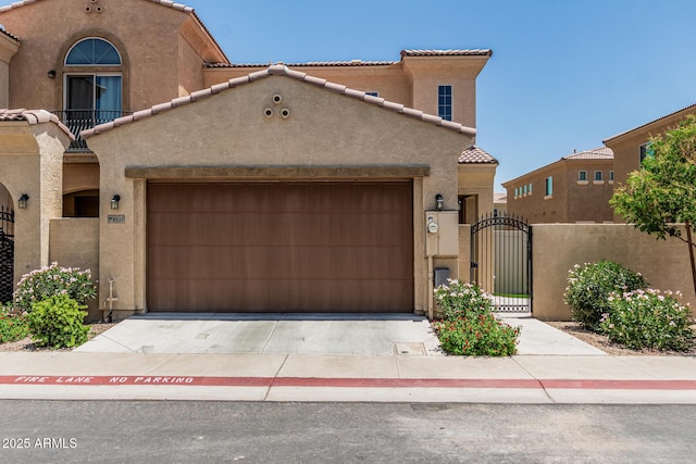 1367 S Country Club Dr Unit 1331, Mesa, AZ 85210 - view of front of home with stucco siding, a tile roof, a gate, and a garage