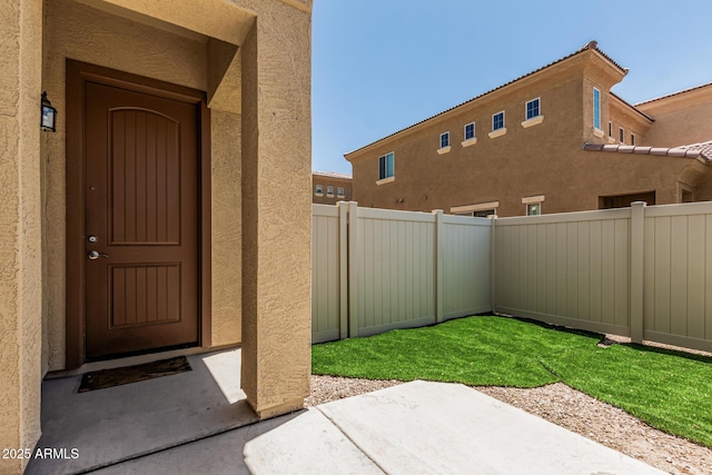 1367 S Country Club Dr Unit 1331, Mesa, AZ 85210 - view of exterior entry featuring stucco siding and a patio