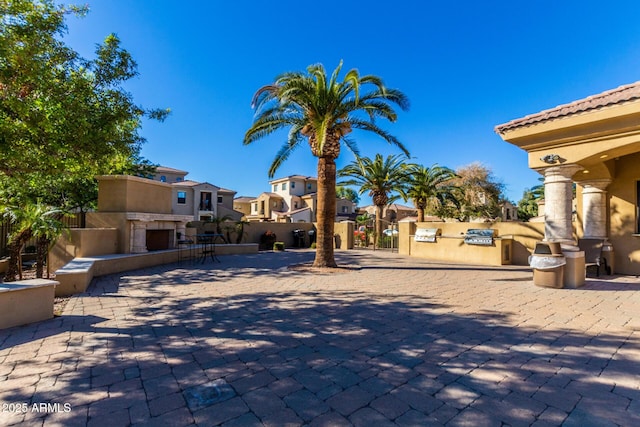 1367 S Country Club Dr Unit 1331, Mesa, AZ 85210 - view of patio / terrace with a residential view, exterior fireplace, and area for grilling
