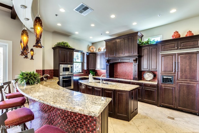 1367 S Country Club Dr Unit 1331, Mesa, AZ 85210 - kitchen featuring built in appliances, a kitchen island with sink, healthy amount of natural light, backsplash, and recessed lighting