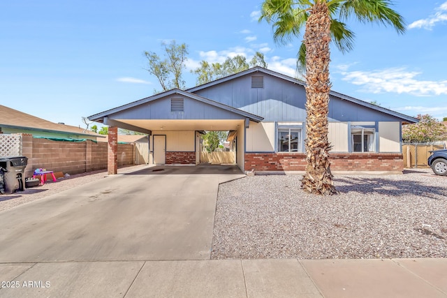 4710 E Camino St, Mesa, AZ 85205 - view of front of home with brick siding, concrete driveway, and fence