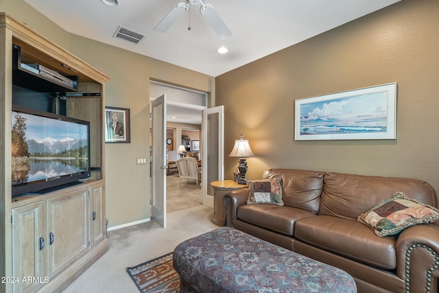 carpeted living room featuring ceiling fan