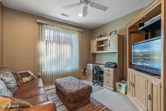 carpeted office with ceiling fan