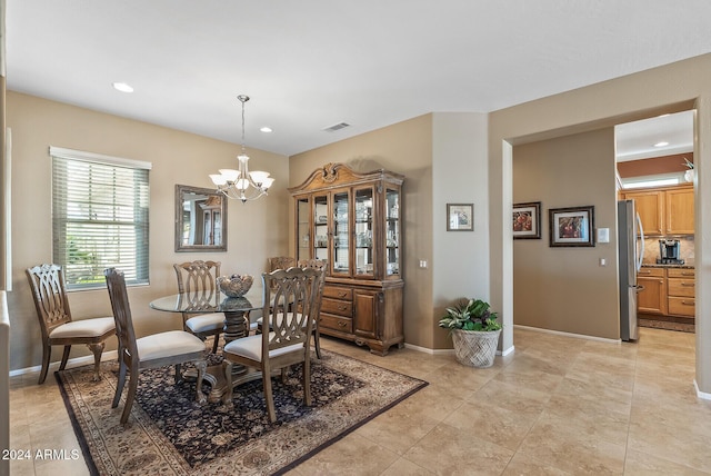 tiled dining area featuring a notable chandelier