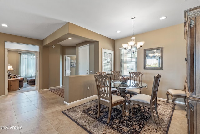 tiled dining room featuring a chandelier