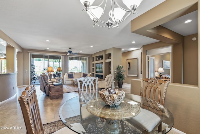 dining space featuring light tile patterned floors and ceiling fan with notable chandelier