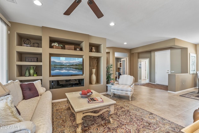 tiled living room with built in shelves, ceiling fan, and a healthy amount of sunlight