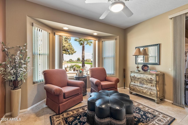 sitting room featuring ceiling fan