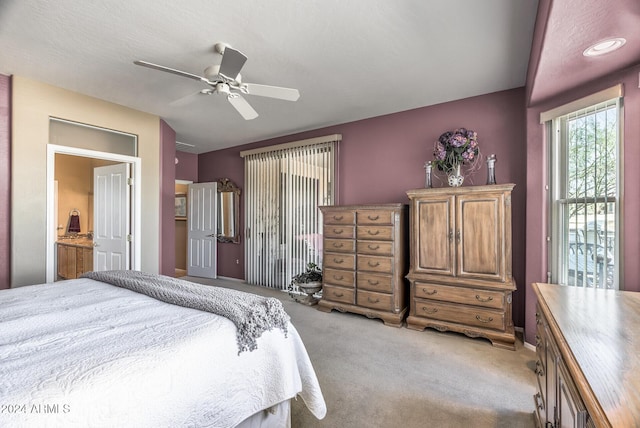 carpeted bedroom featuring ensuite bath and ceiling fan