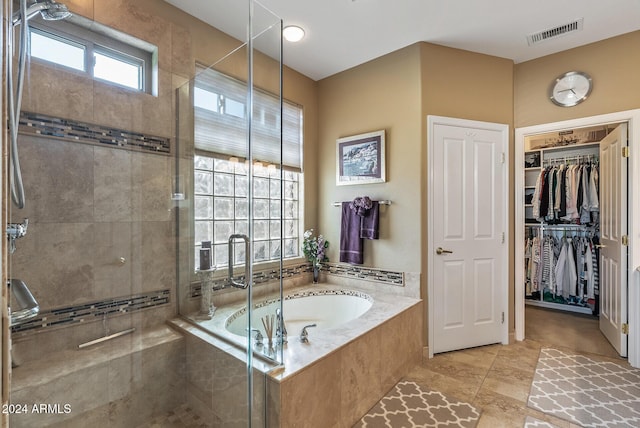 bathroom featuring tile patterned flooring and plus walk in shower