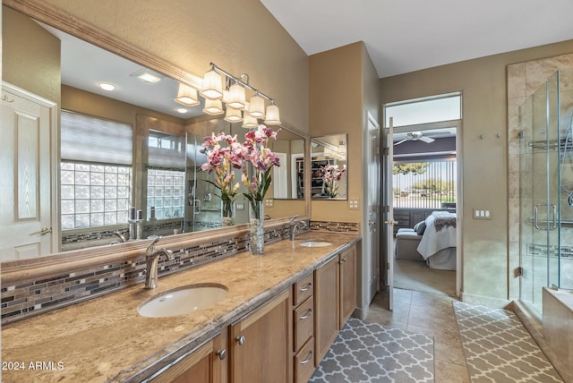 bathroom featuring tasteful backsplash, tile patterned floors, walk in shower, vanity, and ceiling fan