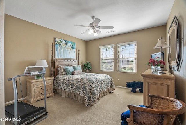 bedroom with ceiling fan and light carpet