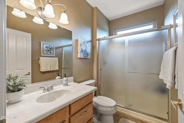 bathroom featuring vanity, toilet, and walk in shower