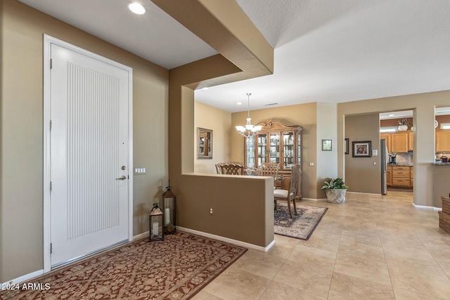 tiled entrance foyer featuring a chandelier