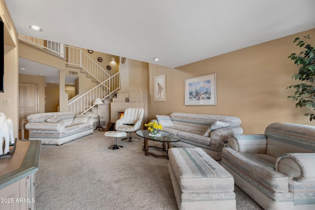 carpeted living room with stairway and recessed lighting