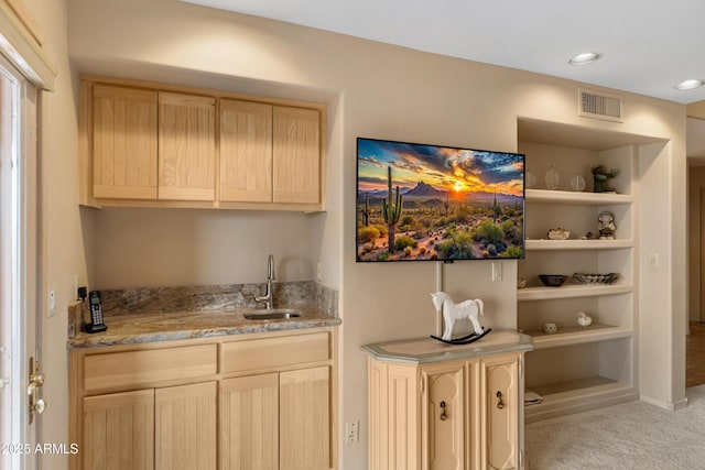 bar featuring visible vents, wet bar, recessed lighting, a sink, and light colored carpet