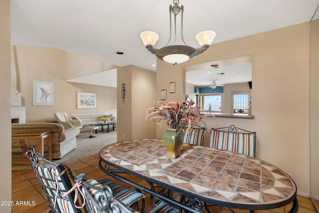 dining area with ceiling fan and carpet flooring