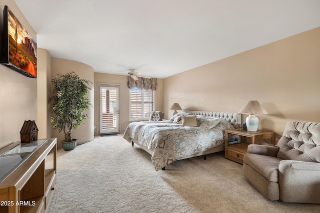 carpeted bedroom featuring access to exterior and a ceiling fan