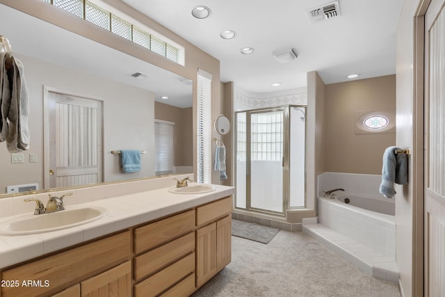 full bathroom featuring visible vents, a garden tub, and a sink