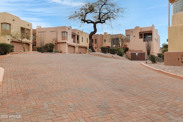 view of building exterior with a residential view and an attached garage