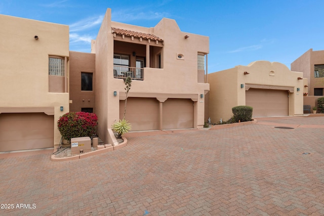 adobe home with stucco siding and a balcony