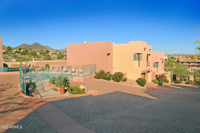 exterior space with fence and a mountain view