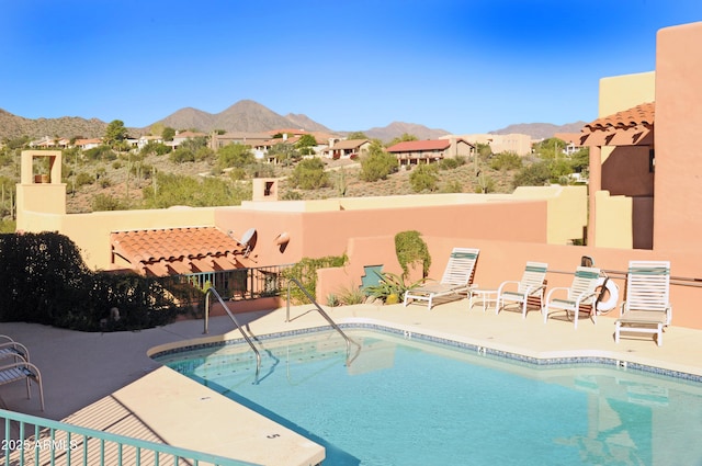 community pool featuring a patio and a mountain view