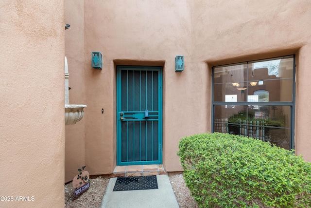 property entrance with stucco siding