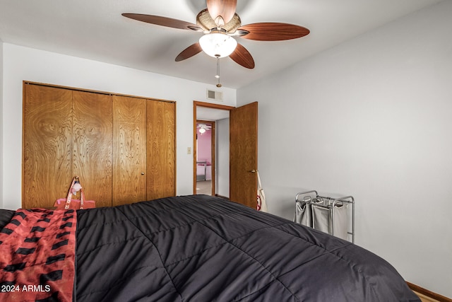 bedroom with ceiling fan and a closet