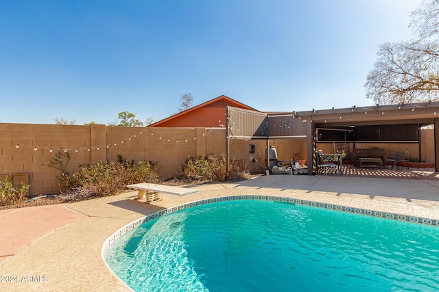 view of pool with an outdoor living space and a patio area