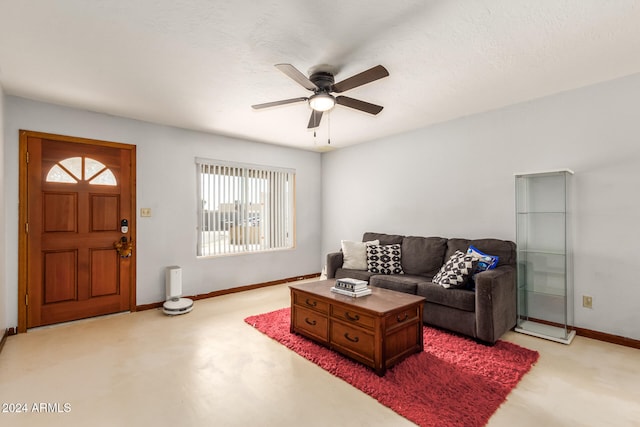 living room with a textured ceiling and ceiling fan