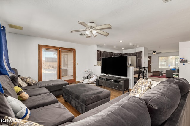 living room featuring a wealth of natural light, hardwood / wood-style flooring, and ceiling fan