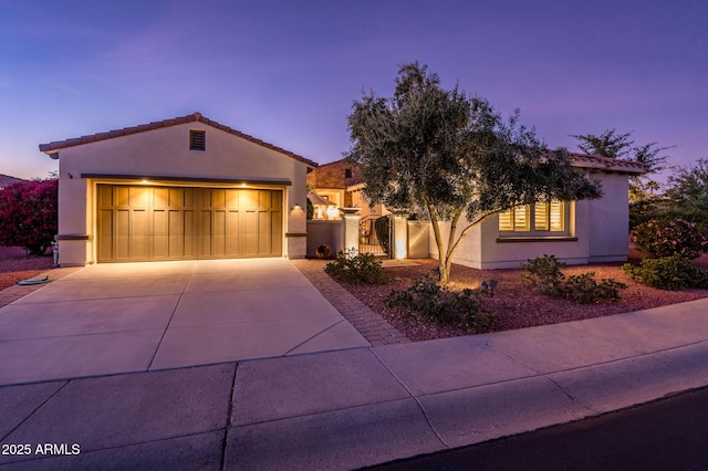 mediterranean / spanish home featuring a garage