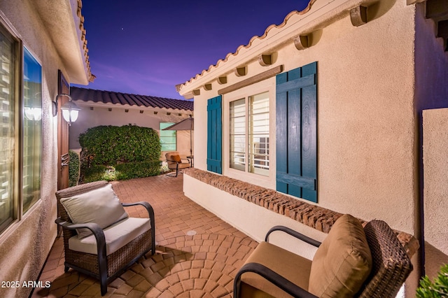 view of patio terrace at dusk