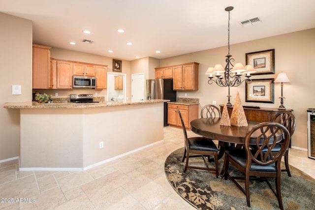 dining room featuring a notable chandelier and wine cooler