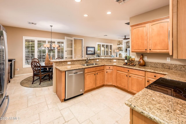 kitchen with kitchen peninsula, ceiling fan with notable chandelier, sink, decorative light fixtures, and dishwasher