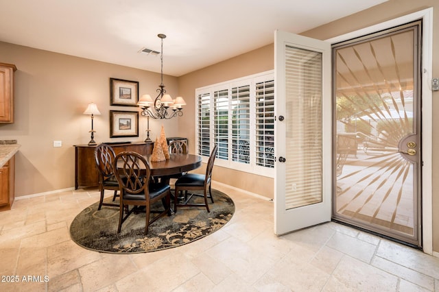 dining space featuring a chandelier