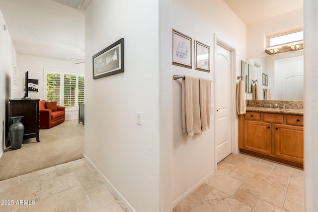 hall featuring light colored carpet