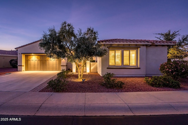 mediterranean / spanish-style home with a garage