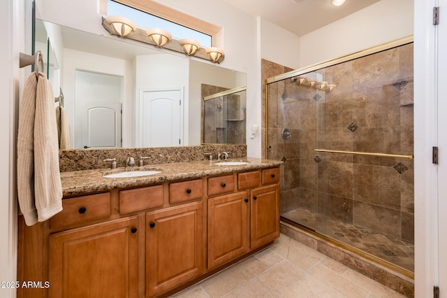 bathroom featuring tile patterned flooring, vanity, and a shower with door