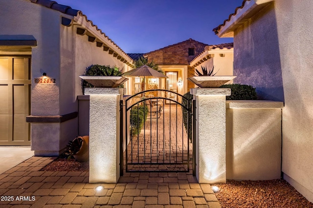 view of gate at dusk