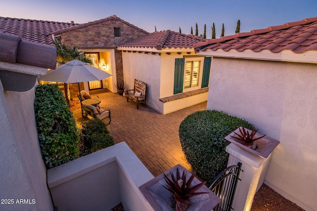 view of patio terrace at dusk