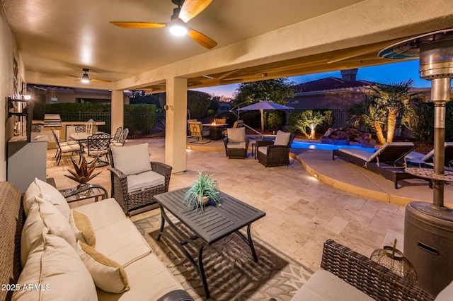 patio terrace at dusk featuring outdoor lounge area and ceiling fan