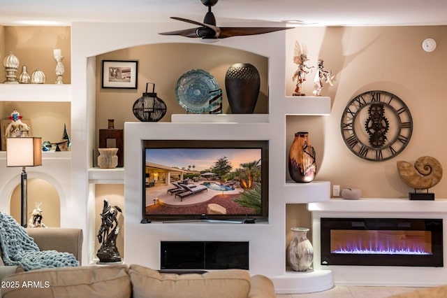 living room featuring ceiling fan and built in features