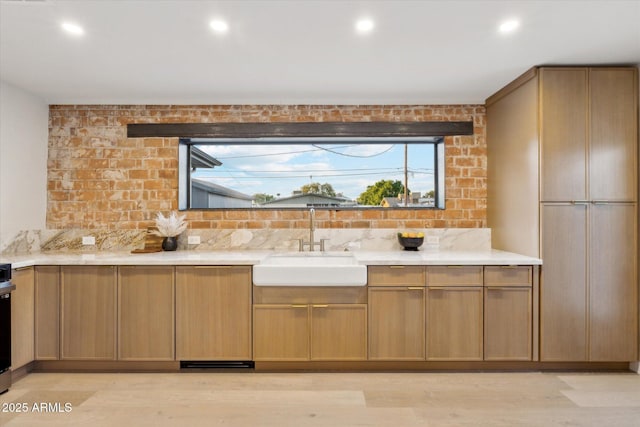 bathroom with recessed lighting and a sink