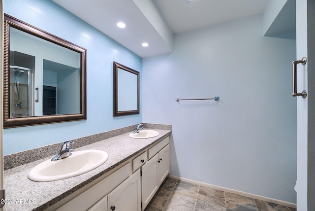 bathroom featuring vanity and an enclosed shower