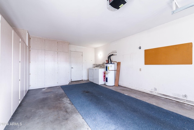 garage with electric water heater, a garage door opener, and washing machine and clothes dryer