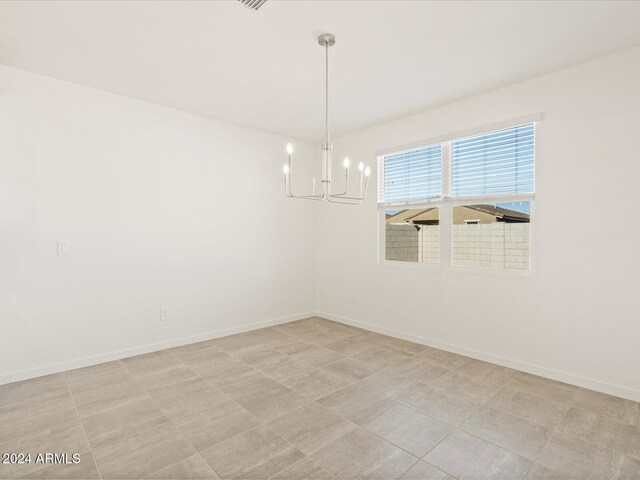 empty room featuring a notable chandelier