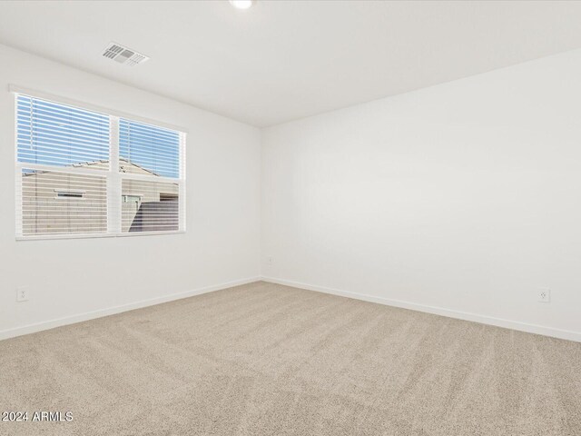 unfurnished room featuring carpet