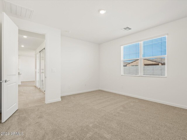 empty room featuring light colored carpet